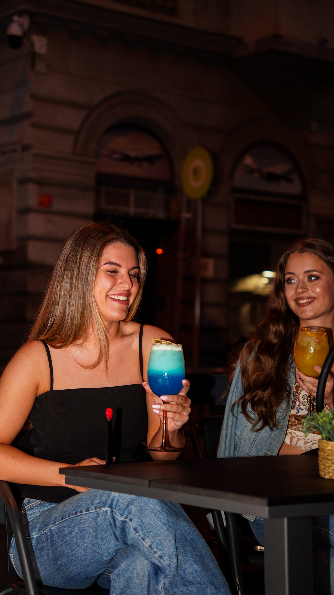 Friends enjoying colorful signature cocktails at 305 Budapest