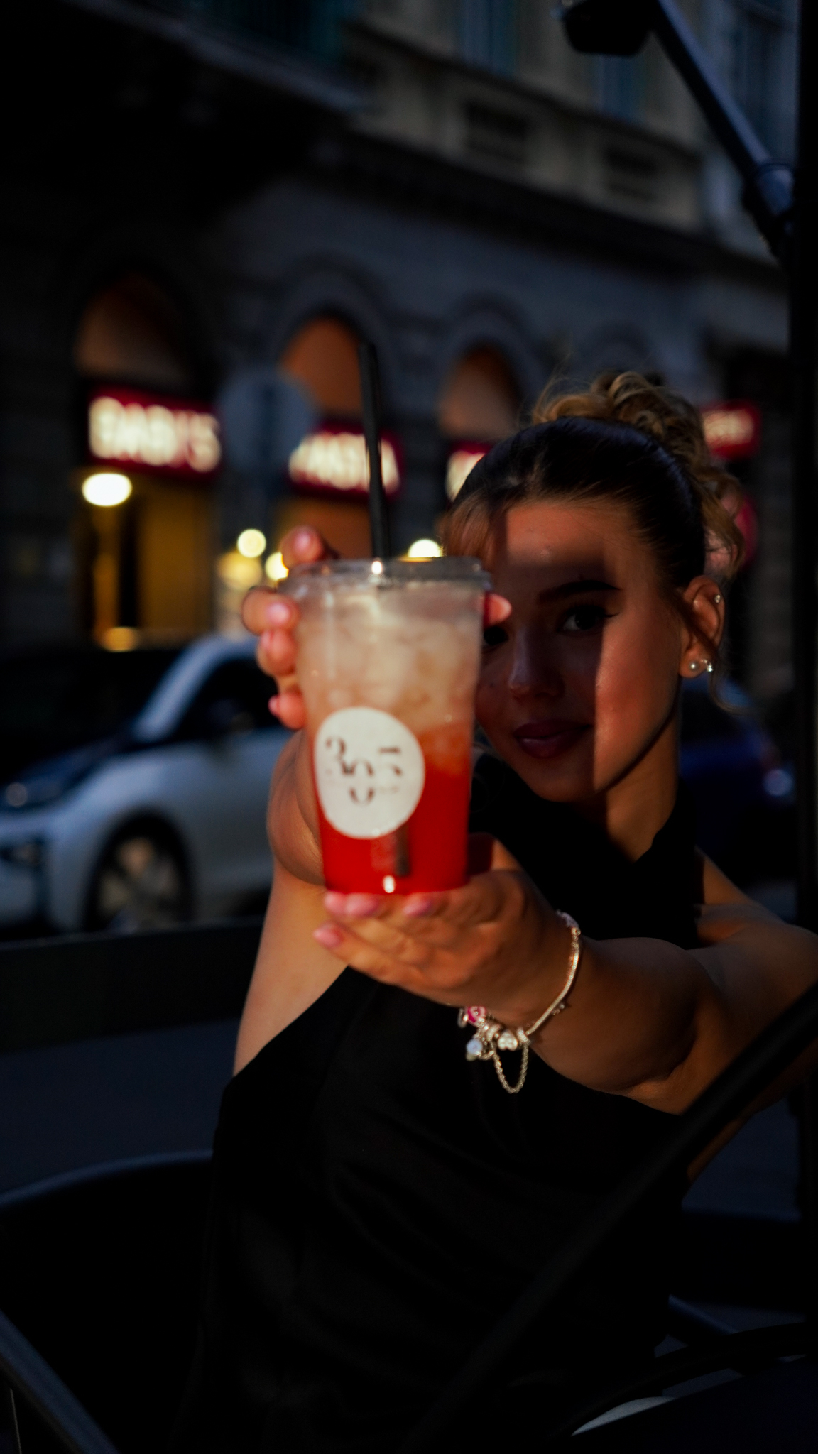 Guest presenting a red cocktail at 305 Budapest